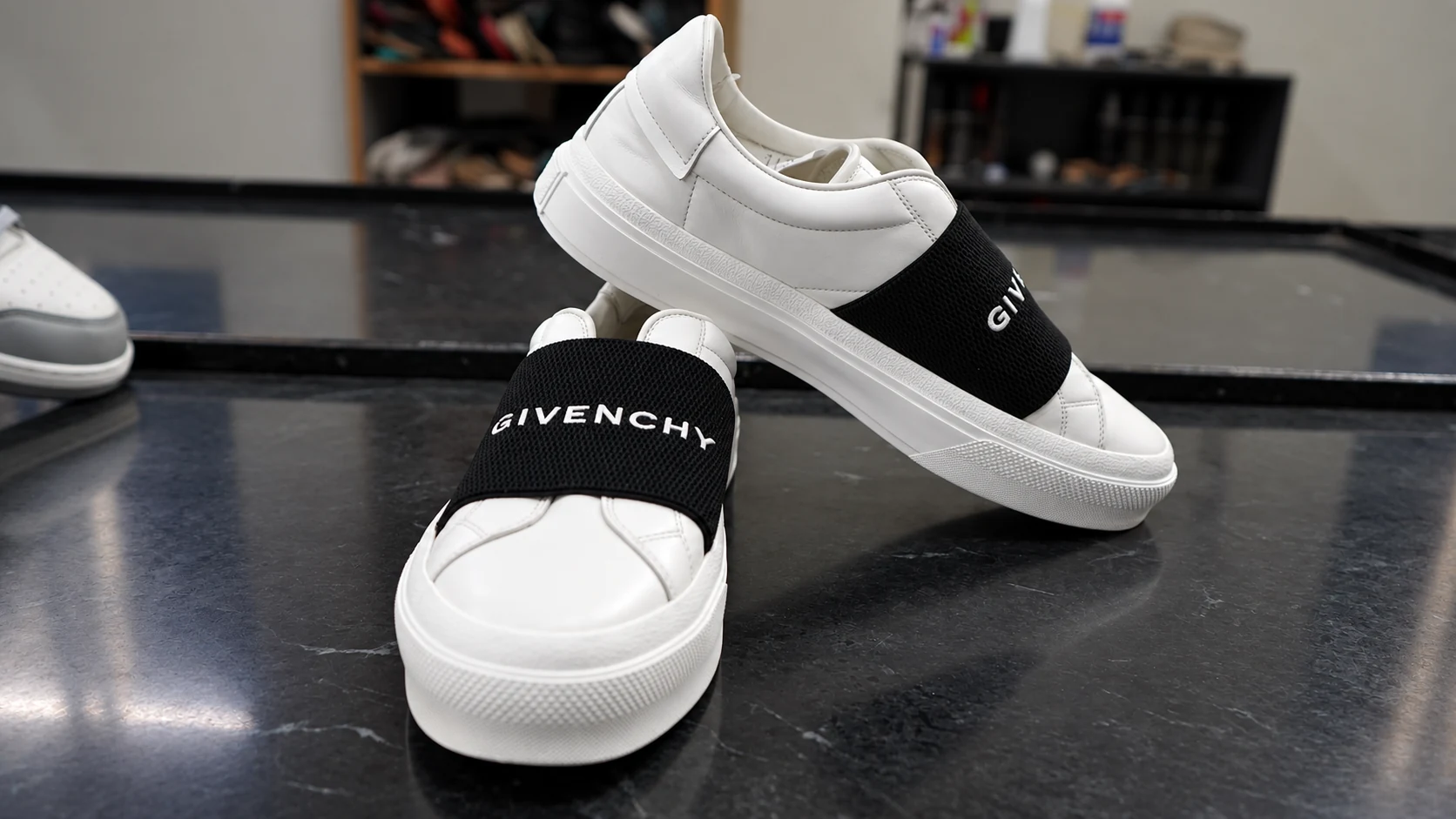 White Givenchy shoes photographed at Mr. Shoe Cleaner