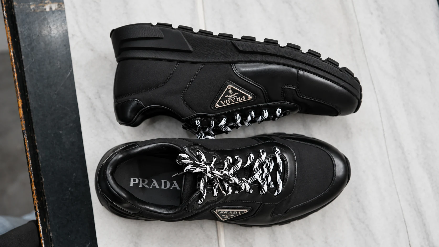 Black premium sneakers photographed from above